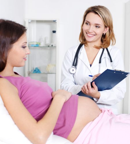 Consultation of pregnant young woman with doctor in hospital - indoors