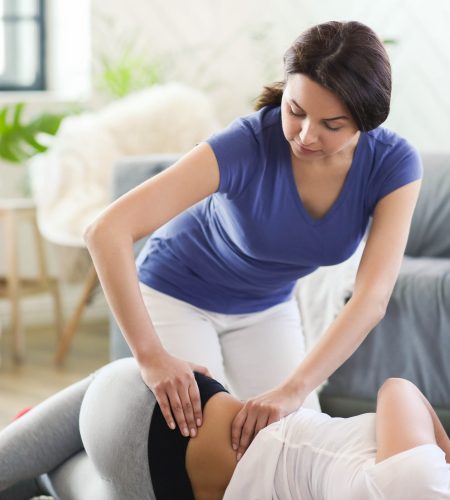 Woman is getting physical therapy from a professional doctor